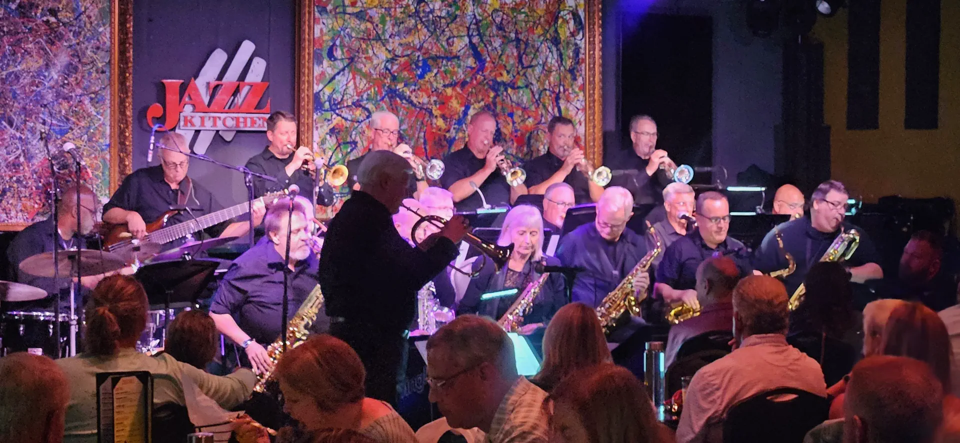 JoySwing Jazz Orchestra performing for a full audience